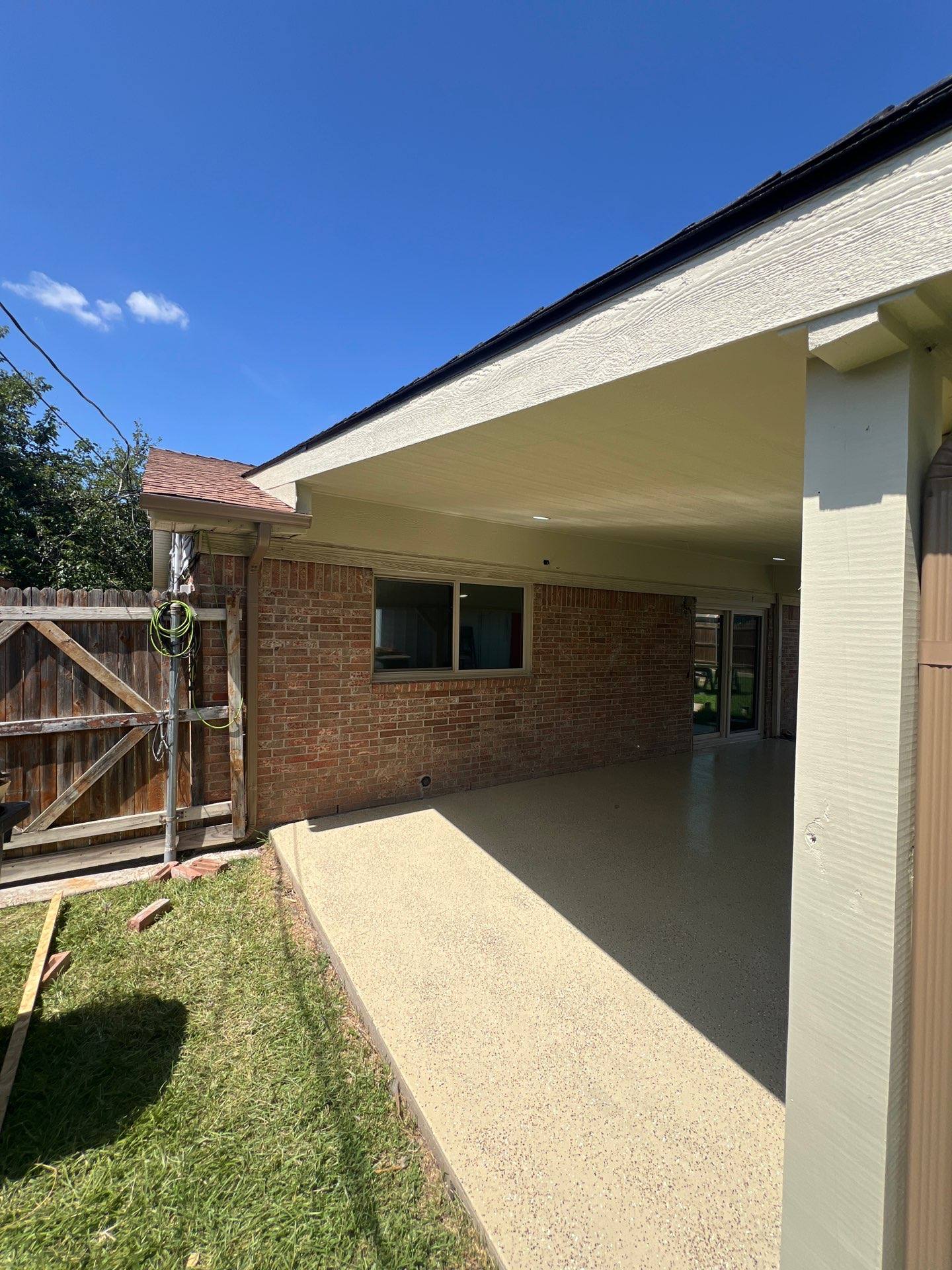 Rebuilt metal patio cover and roofing on an Arlington, TX home covered under a hail insurance claim