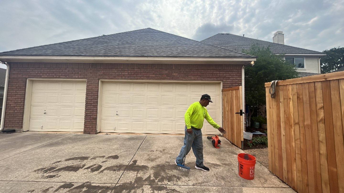 Completed roof replacement on a Grapevine, TX home with a Becker Roofing crew member magnet sweeping the driveway